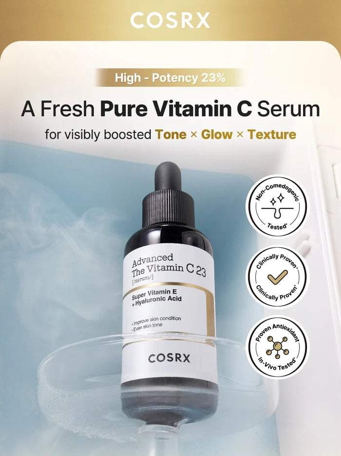COSRX Advanced The Vitamin C 23 Serum displayed on an icy blue background with clinical proof badges for non-comedogenic, antioxidant, and clinically proven results; formulated with 23% pure Vitamin C to visibly improve tone, glow, and texture while reducing dark spots and refining pores.