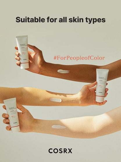 Arms of diverse skin tones with COSRX Vitamin E Vitalizing Sunscreen SPF 50+ applied, captioned ‘Suitable for All Skin Types’; transparent K-beauty formula #ForPeopleofColor that absorbs without white cast or greasiness, ideal for daily hydration and makeup prep.