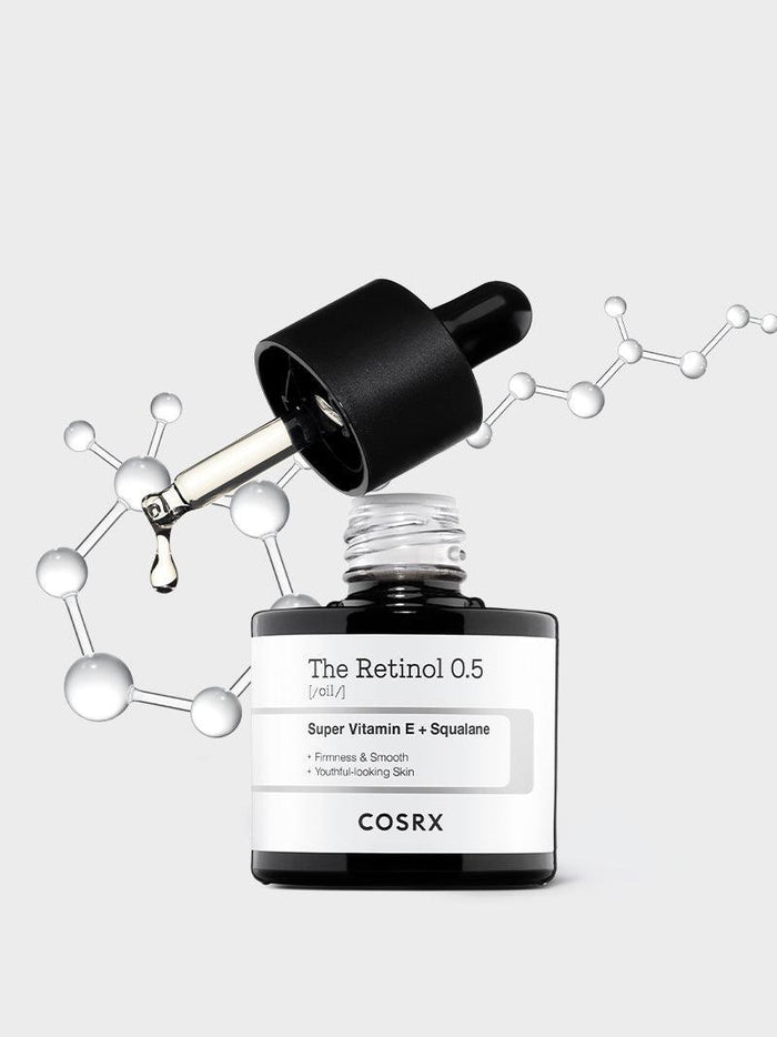 Hero shot of COSRX The Retinol 0.5 Oil with molecular graphics; 0.5% pure stabilized retinol blended with Super Vitamin E + squalane for firmness, smoothness, and youthful glow; ideal for advanced retinol users seeking anti-aging and acne-compatible retinol care.